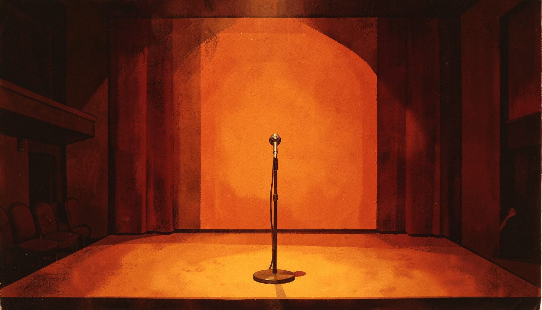 A warm, dimly lit theatre interior with a single microphone on a bare stage, deep amber and burgundy tones, intimate and expectant atmosphere.